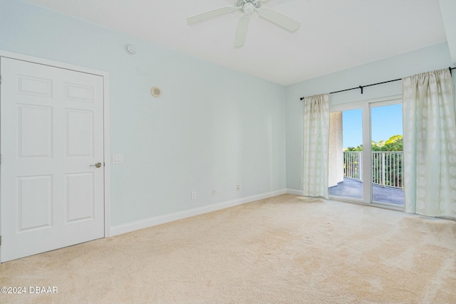 unfurnished room with ceiling fan and light colored carpet