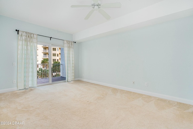 spare room with ceiling fan and carpet