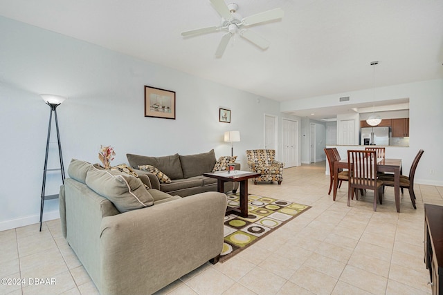 living room with ceiling fan and light tile patterned flooring