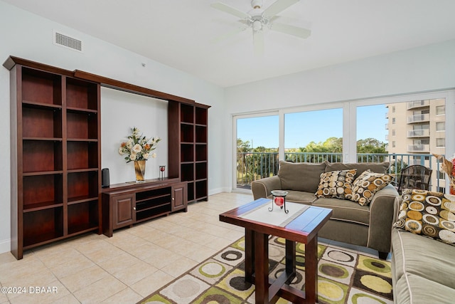 living room with ceiling fan and light tile patterned flooring