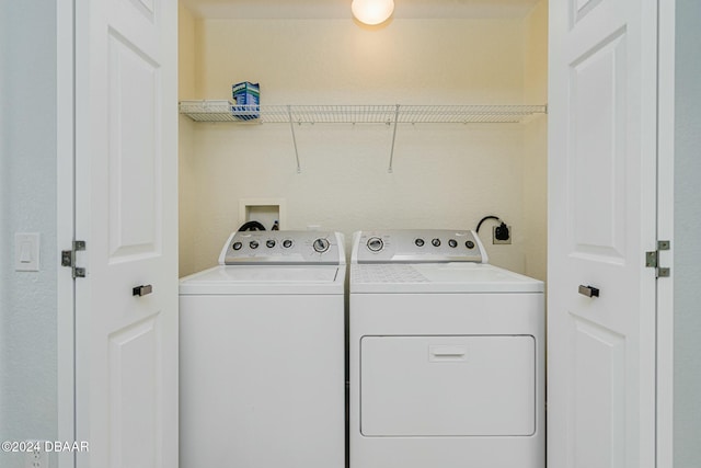 clothes washing area featuring separate washer and dryer