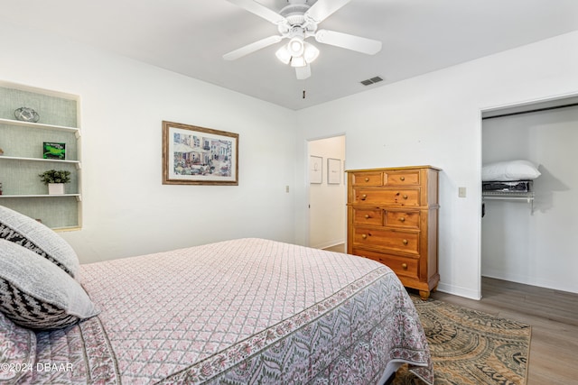 bedroom with a closet, ceiling fan, and hardwood / wood-style floors