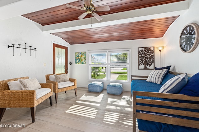 sunroom with vaulted ceiling, ceiling fan, and wooden ceiling