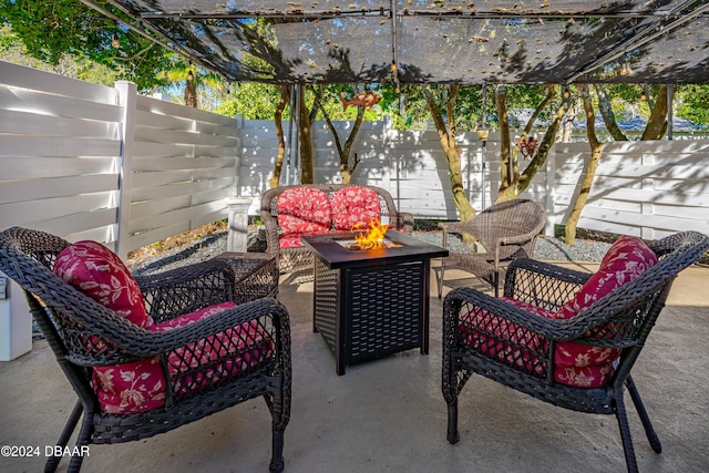 view of patio featuring a pergola and an outdoor living space with a fire pit