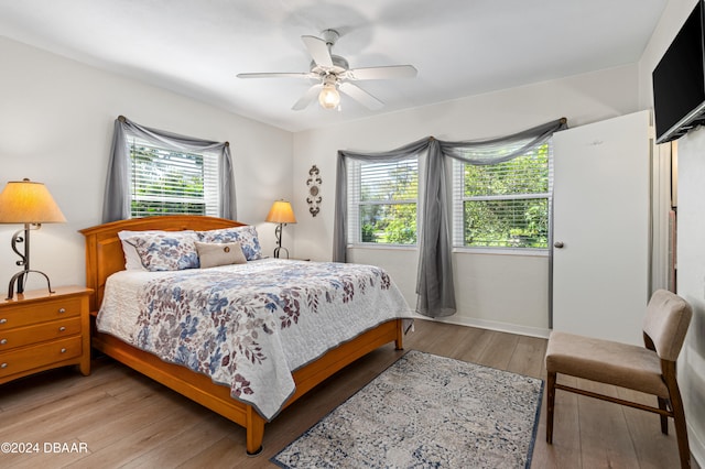 bedroom with light hardwood / wood-style flooring and ceiling fan