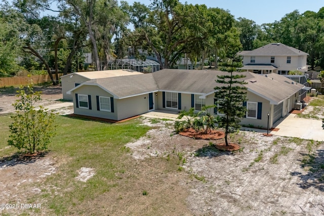 131 Lake Charles Rd, Deland, FL 32724 - view of front of house featuring driveway, fence, roof with shingles, and view of wooded area