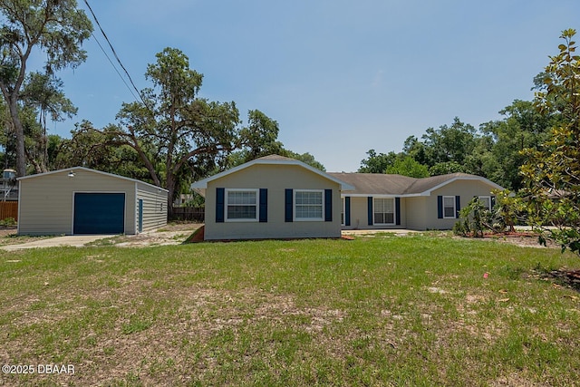 131 Lake Charles Rd, Deland, FL 32724 - back of house featuring a detached garage, an outdoor structure, and driveway