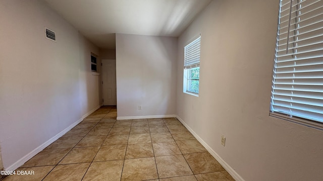 unfurnished room featuring light tile patterned floors