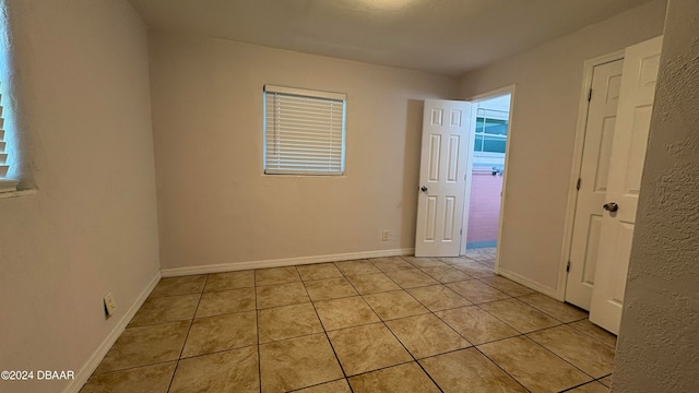 spare room with light tile patterned flooring