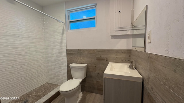 bathroom featuring vanity, toilet, tile walls, and a shower with curtain