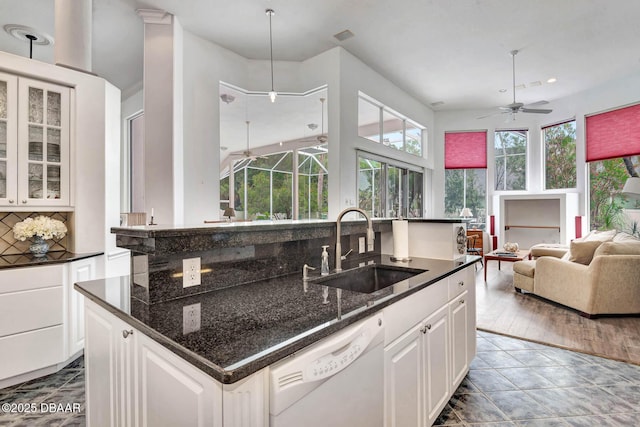 2 Creek Bend Way, Ormond Beach, FL 32174 - kitchen with white dishwasher, ceiling fan, an island with sink, open floor plan, and backsplash