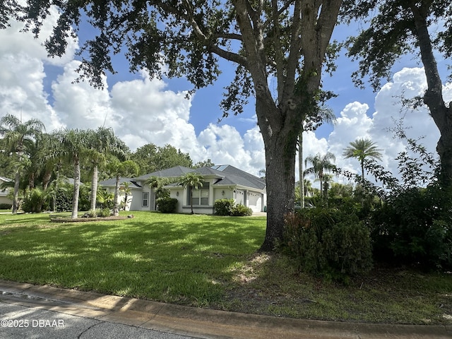 2 Creek Bend Way, Ormond Beach, FL 32174 - view of front of house featuring an attached garage and a front lawn