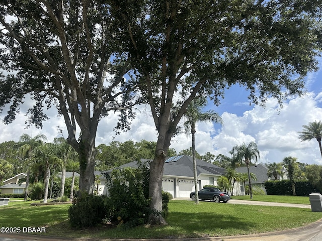 2 Creek Bend Way, Ormond Beach, FL 32174 - view of side of property featuring an attached garage, a yard, and driveway