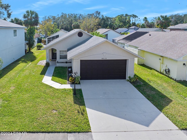 view of front facade with a front yard and a garage