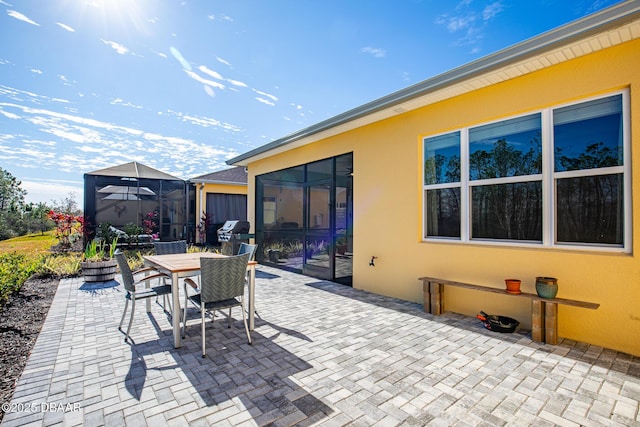 view of patio / terrace featuring a lanai and grilling area