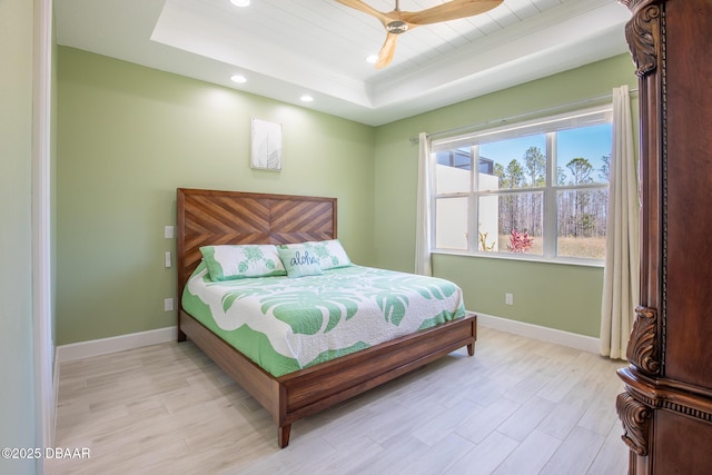 bedroom featuring a tray ceiling and ceiling fan