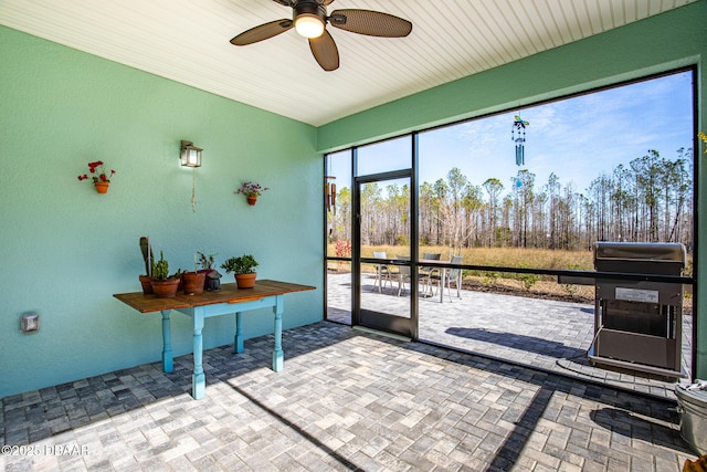 doorway to outside with ceiling fan