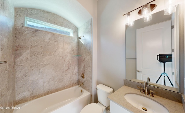 full bathroom featuring vanity, toilet, and tiled shower / bath