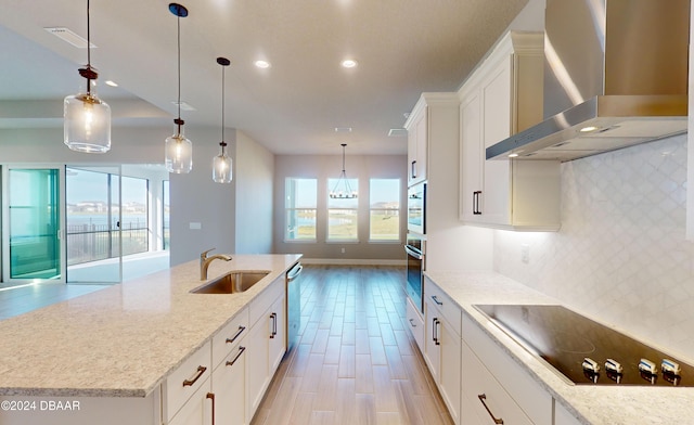 kitchen with white cabinetry, sink, wall chimney exhaust hood, and appliances with stainless steel finishes