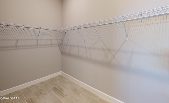 walk in closet featuring hardwood / wood-style floors