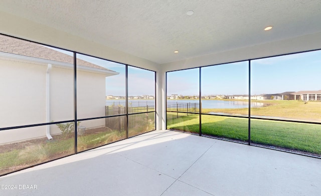 unfurnished sunroom with a water view