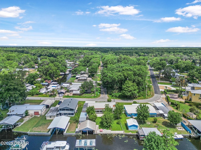 aerial view with a water view, a view of trees, and a residential view