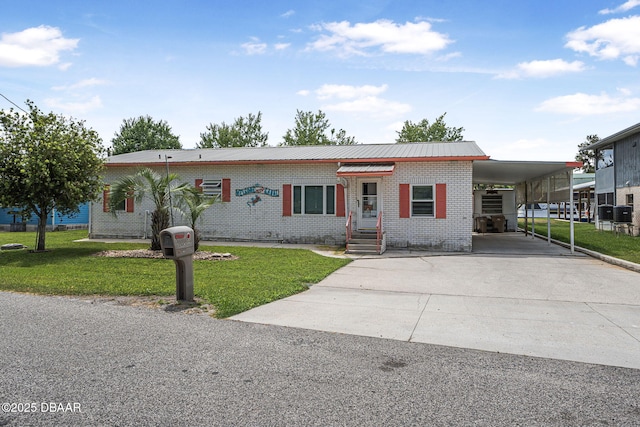 view of front facade featuring concrete driveway, brick siding, a front yard, and an attached carport