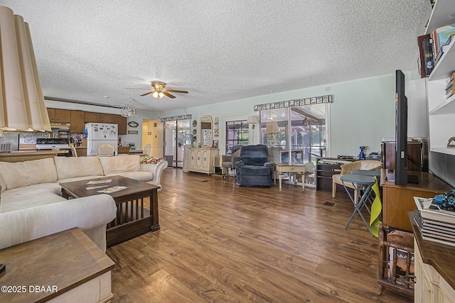 living room featuring a textured ceiling, ceiling fan, and wood finished floors