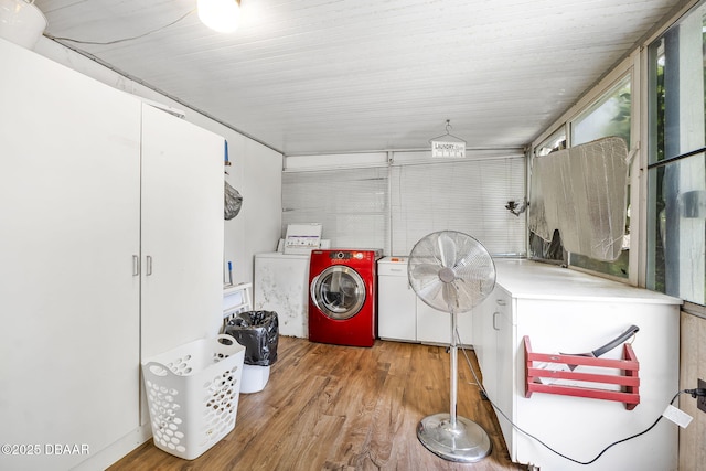 washroom featuring laundry area, wood finished floors, and washer and dryer