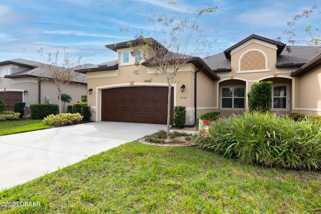 view of front of house featuring a garage and a front yard