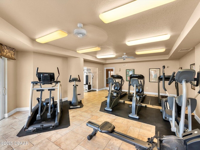 2403 S Atlantic Ave Unit 410, Daytona Beach, FL 32118 - gym with baseboards, a tray ceiling, a textured ceiling, and ceiling fan