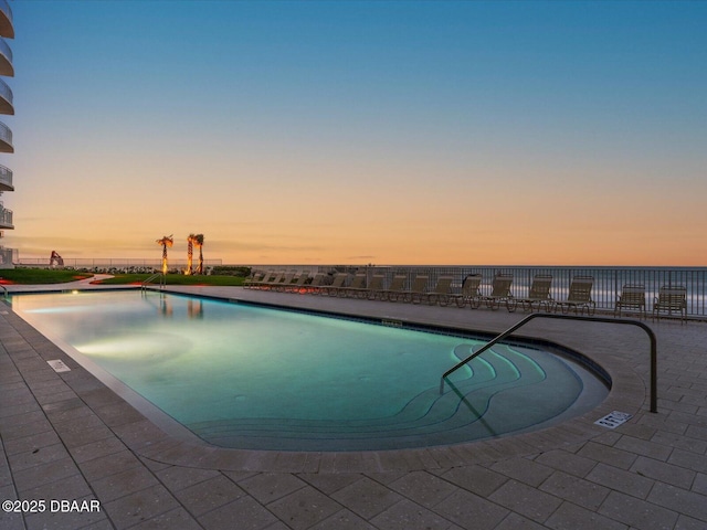 2403 S Atlantic Ave Unit 410, Daytona Beach, FL 32118 - pool at dusk featuring a community pool and a patio area
