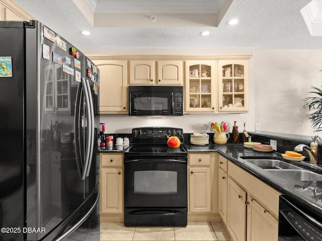 2403 S Atlantic Ave Unit 410, Daytona Beach, FL 32118 - kitchen with black appliances, a sink, cream cabinetry, dark countertops, and recessed lighting
