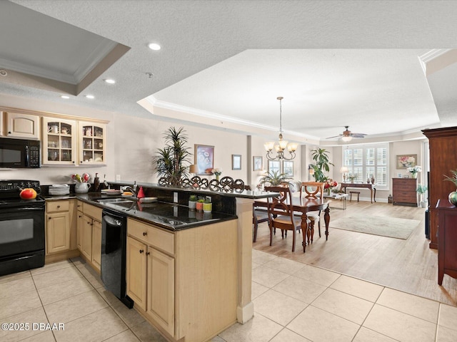 2403 S Atlantic Ave Unit 410, Daytona Beach, FL 32118 - kitchen featuring black appliances, a raised ceiling, crown molding, a peninsula, and cream cabinets