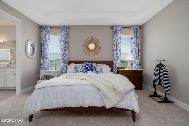 3013 Kenmare St, Ormond Beach, FL 32174 - bedroom featuring a raised ceiling, light carpet, and ensuite bath