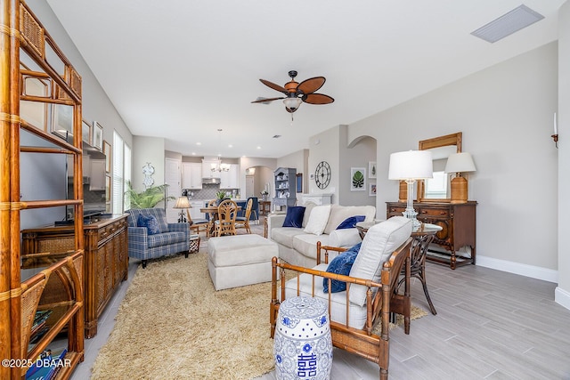 3013 Kenmare St, Ormond Beach, FL 32174 - living room with a ceiling fan, arched walkways, baseboards, light wood finished floors, and recessed lighting