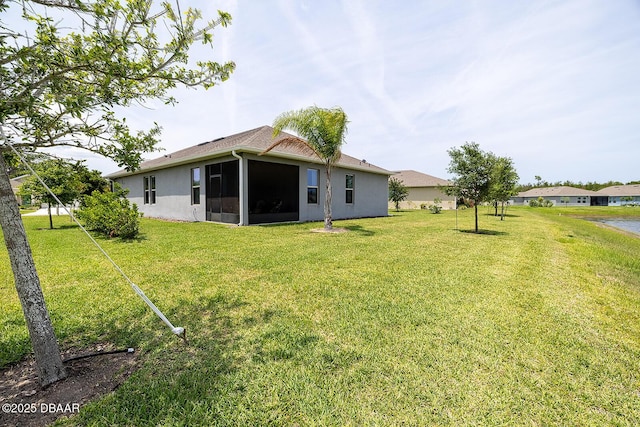 3013 Kenmare St, Ormond Beach, FL 32174 - rear view of house featuring a lawn, a sunroom, and stucco siding