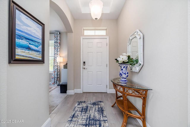 3013 Kenmare St, Ormond Beach, FL 32174 - entrance foyer with arched walkways, light wood-style flooring, and baseboards