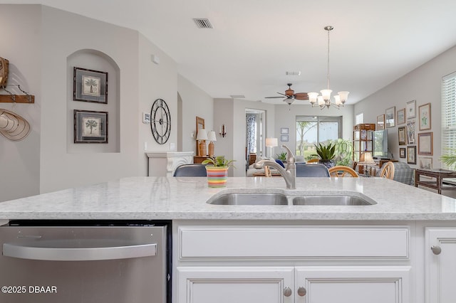 3013 Kenmare St, Ormond Beach, FL 32174 - kitchen featuring dishwasher, a sink, a chandelier, and light stone countertops
