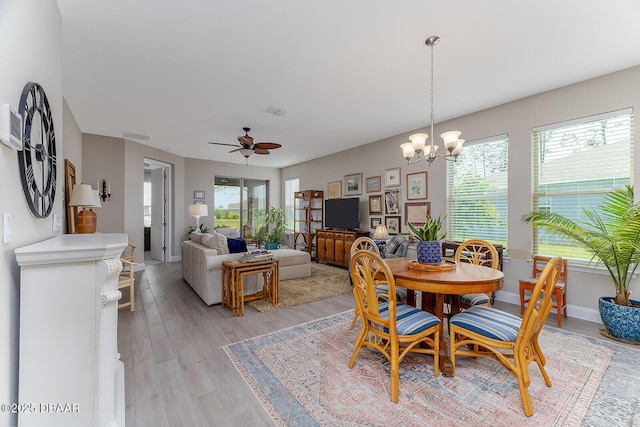 3013 Kenmare St, Ormond Beach, FL 32174 - dining room featuring plenty of natural light, a chandelier, light wood finished floors, and a ceiling fan
