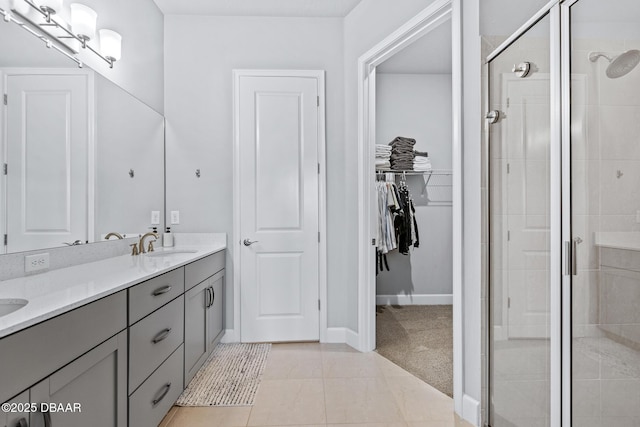 6423 Hanfield Ln, Port Orange, FL 32128 - bathroom featuring double vanity, a shower stall, a spacious closet, and tile patterned floors