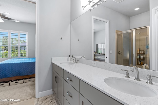 6423 Hanfield Ln, Port Orange, FL 32128 - ensuite bathroom featuring double vanity, a stall shower, and a ceiling fan