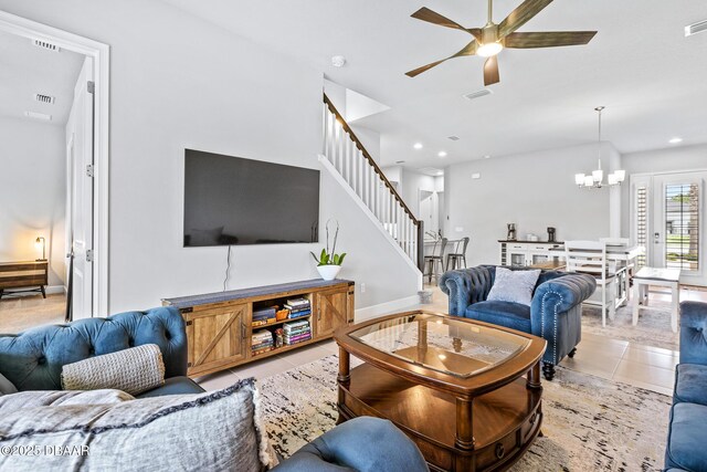 6423 Hanfield Ln, Port Orange, FL 32128 - living room with stairs, a chandelier, light tile patterned floors, a ceiling fan, and recessed lighting