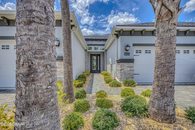 6423 Hanfield Ln, Port Orange, FL 32128 - view of front facade with stone siding, a garage, stucco siding, and roof with shingles