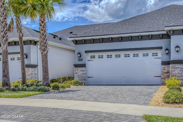 6423 Hanfield Ln, Port Orange, FL 32128 - view of front facade featuring stone siding, stucco siding, an attached garage, and decorative driveway