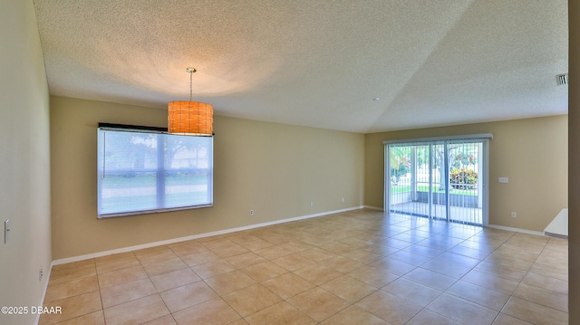 spare room featuring visible vents, a textured ceiling, baseboards, and light tile patterned floors