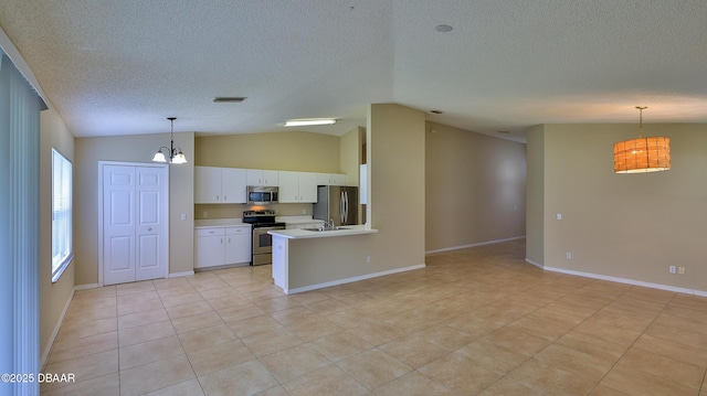 kitchen with a notable chandelier, a textured ceiling, visible vents, and stainless steel appliances