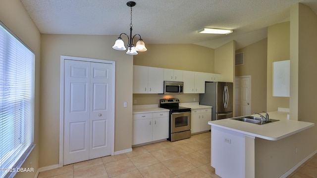 kitchen with light tile patterned floors, a chandelier, stainless steel appliances, and a sink