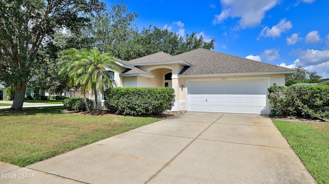 ranch-style house with a garage, concrete driveway, a front yard, and stucco siding