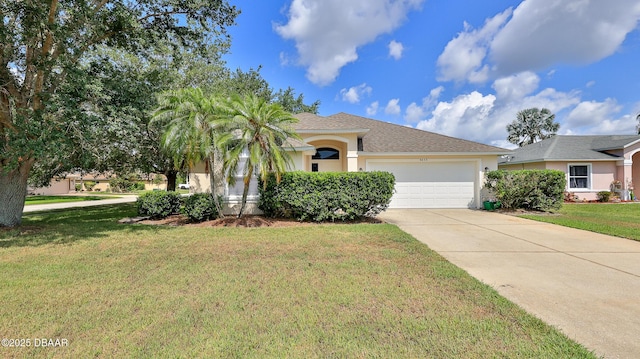 view of front facade featuring an attached garage, driveway, a front lawn, and stucco siding